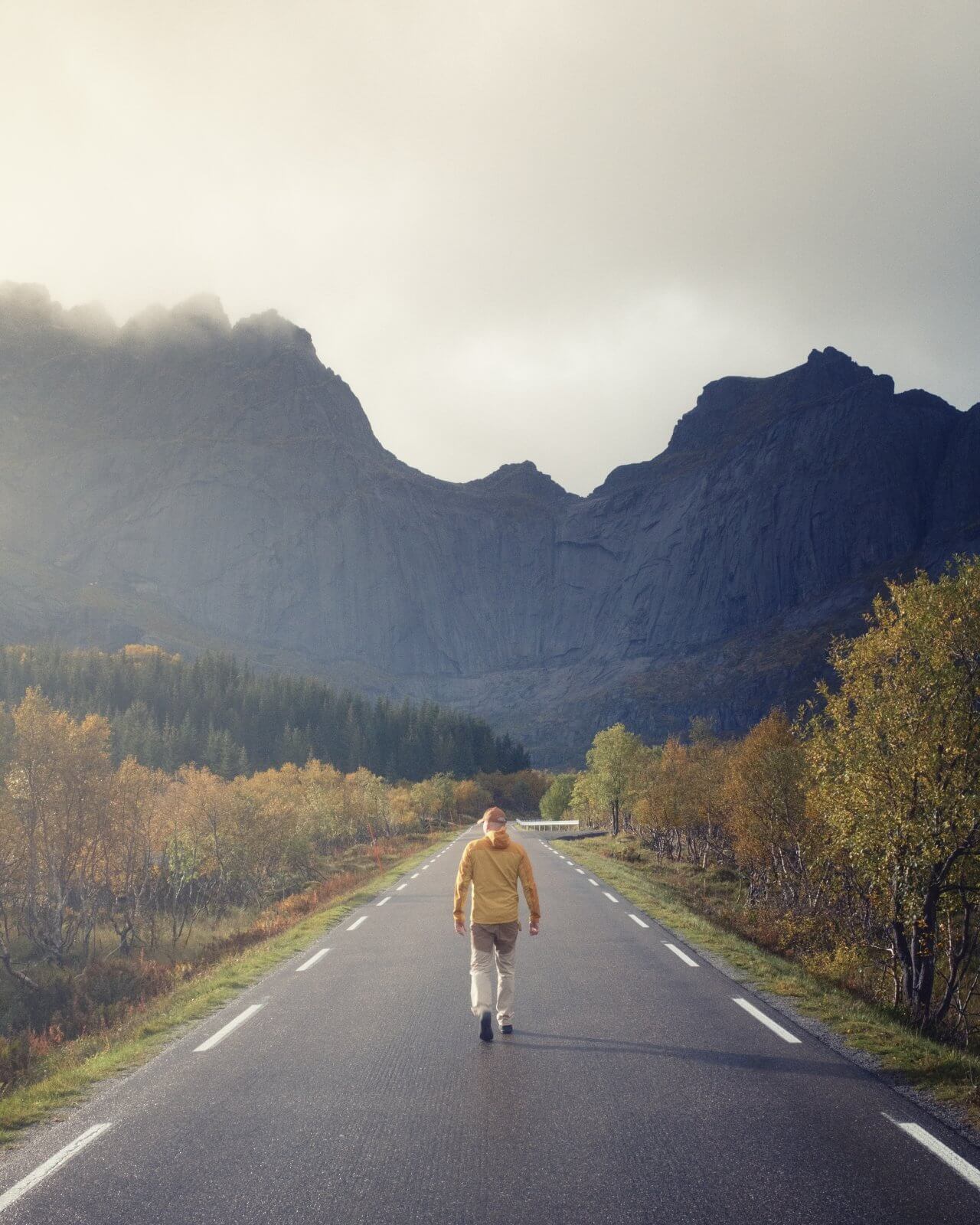 Ma walking on a road during a sunny day in Lofoten Norway